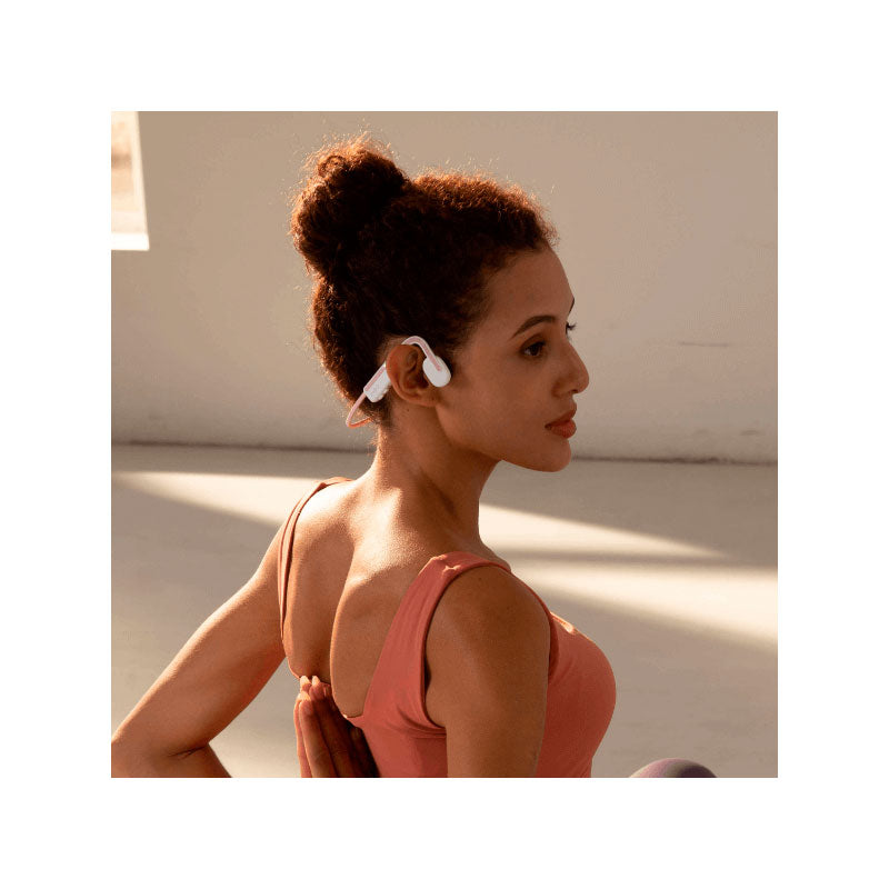 Mujer usando Audífonos AFTERSHOKZ Open Move / Himalayan Pink deportivos
